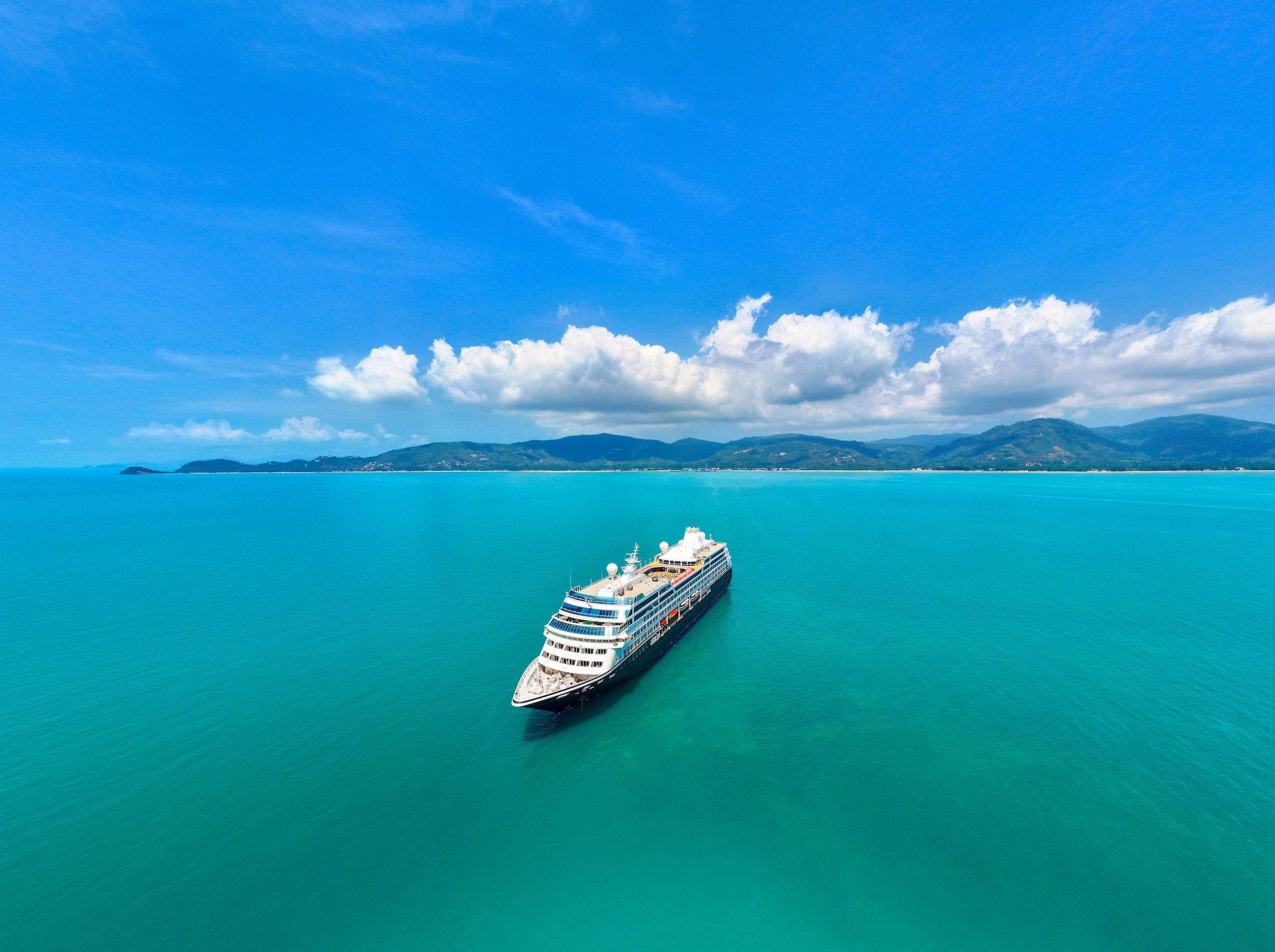 Cruise ship surrounded by brilliant blue ocean